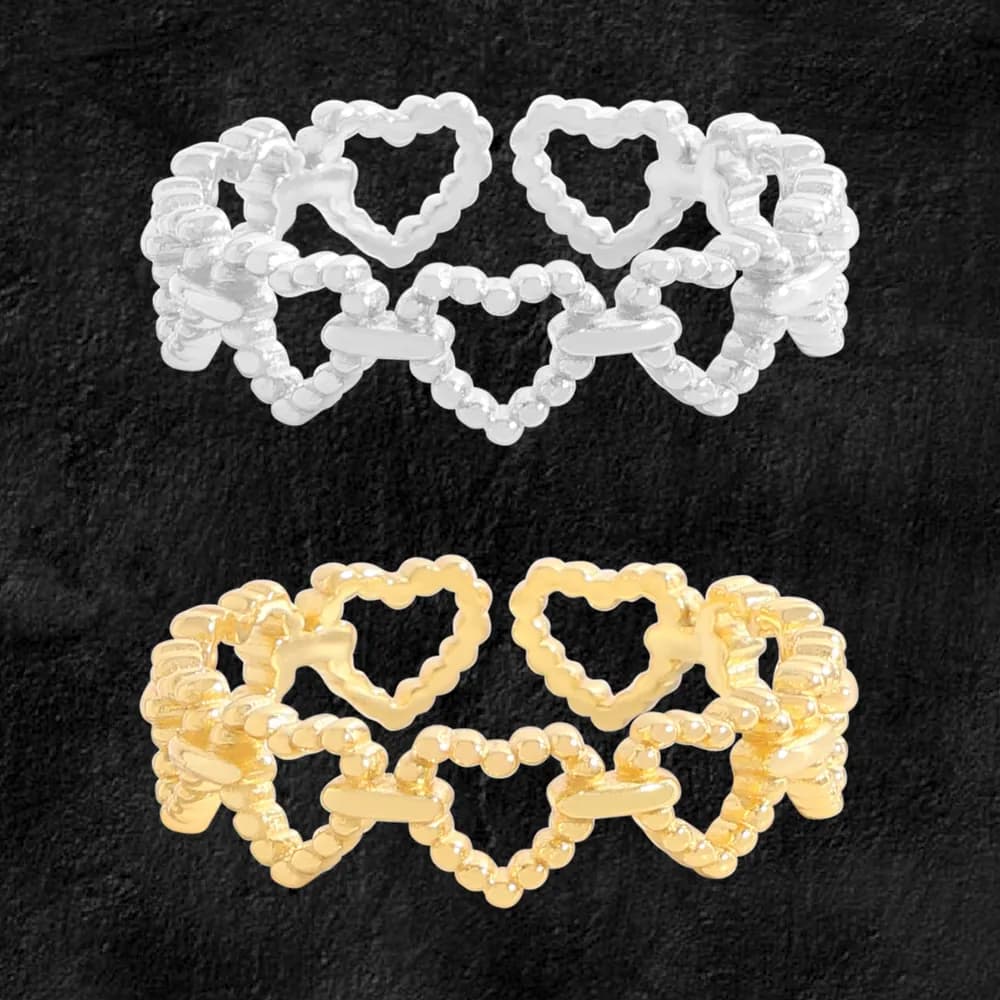 Polished beaded heart-link ring shown in silver and gold tones on a dark background.