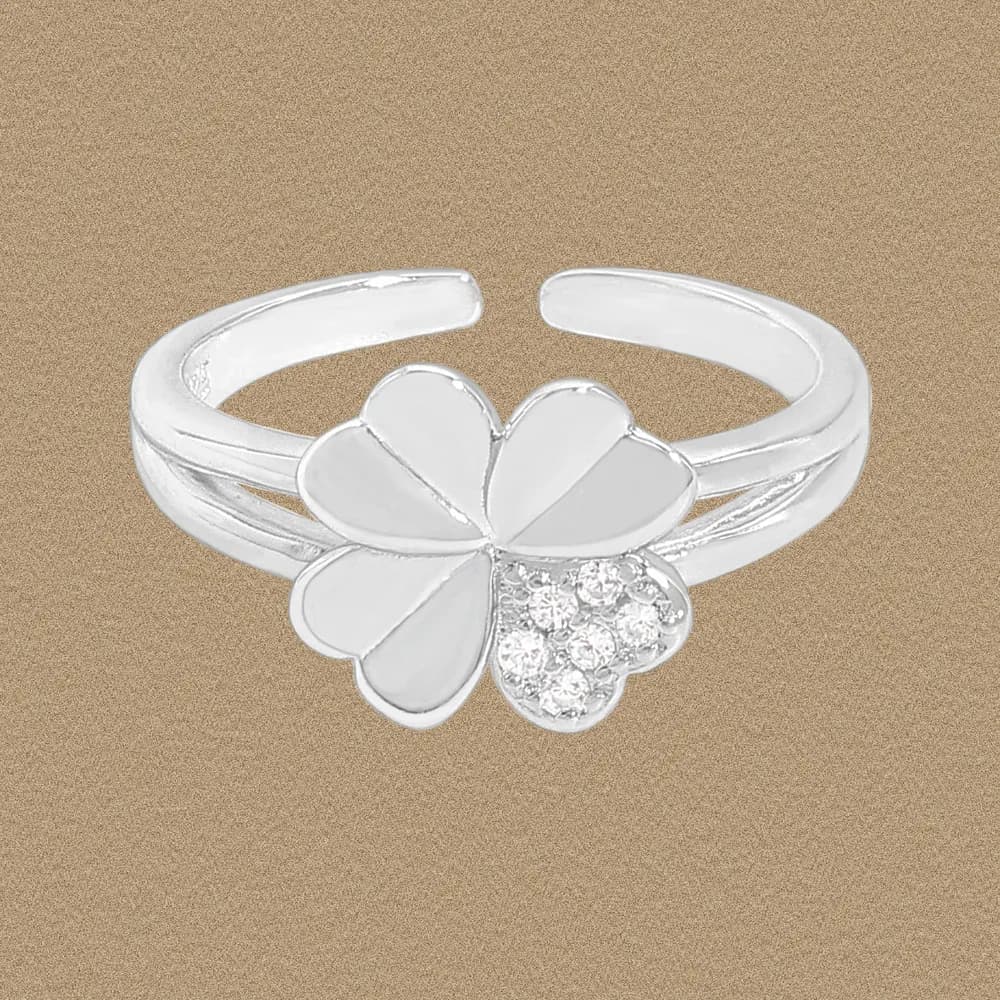 A polished sterling silver ring with a five-petal flower centerpiece and a split-band design.