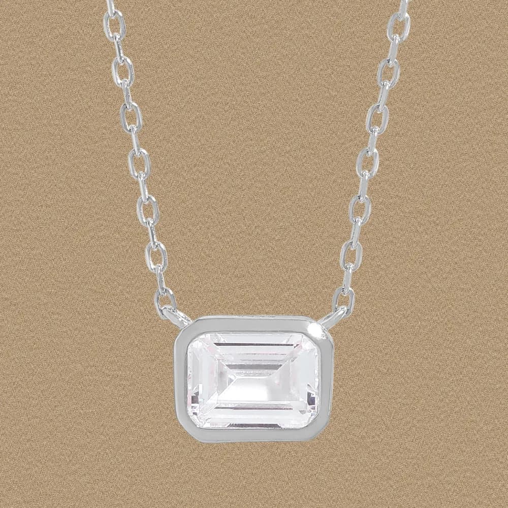 Sterling silver necklace with an emerald-cut clear stone in a bezel setting on a delicate chain