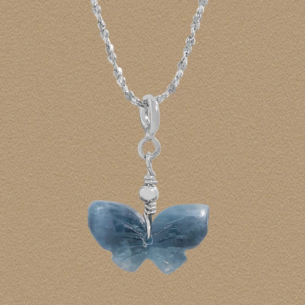 Sterling silver chain with a blue butterfly pendant hanging as a focal point