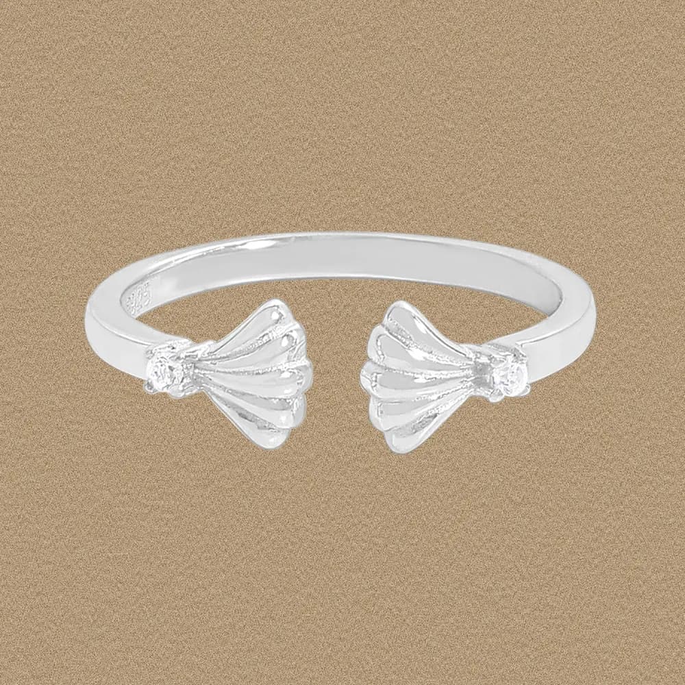 Polished sterling silver open ring with twin fan-shell ends on a gold-toned background.
