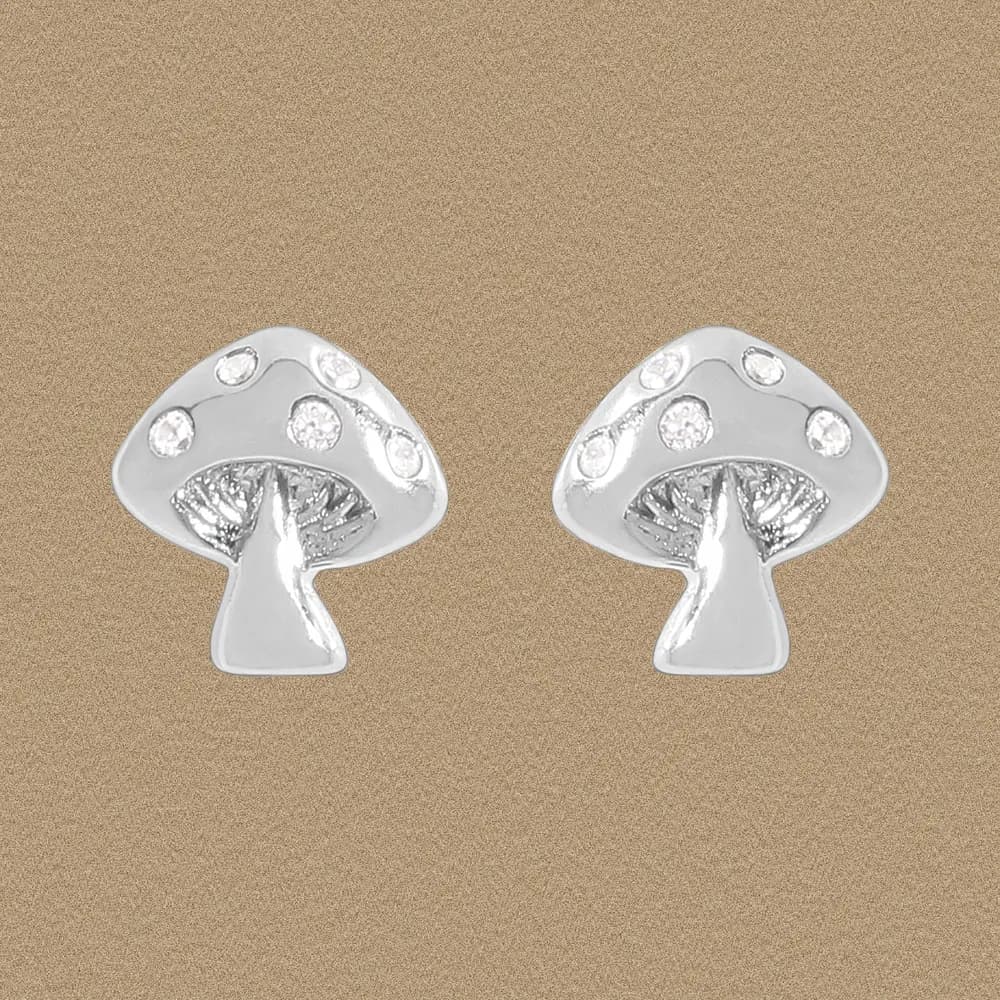 A pair of polished silver mushroom-cap stud earrings shown on a neutral background.