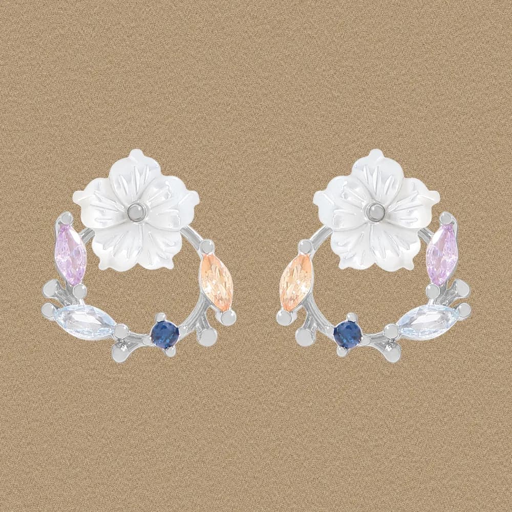 Polished sterling silver floral hoop earrings with pastel marquise stones and a prominent flower at the top.