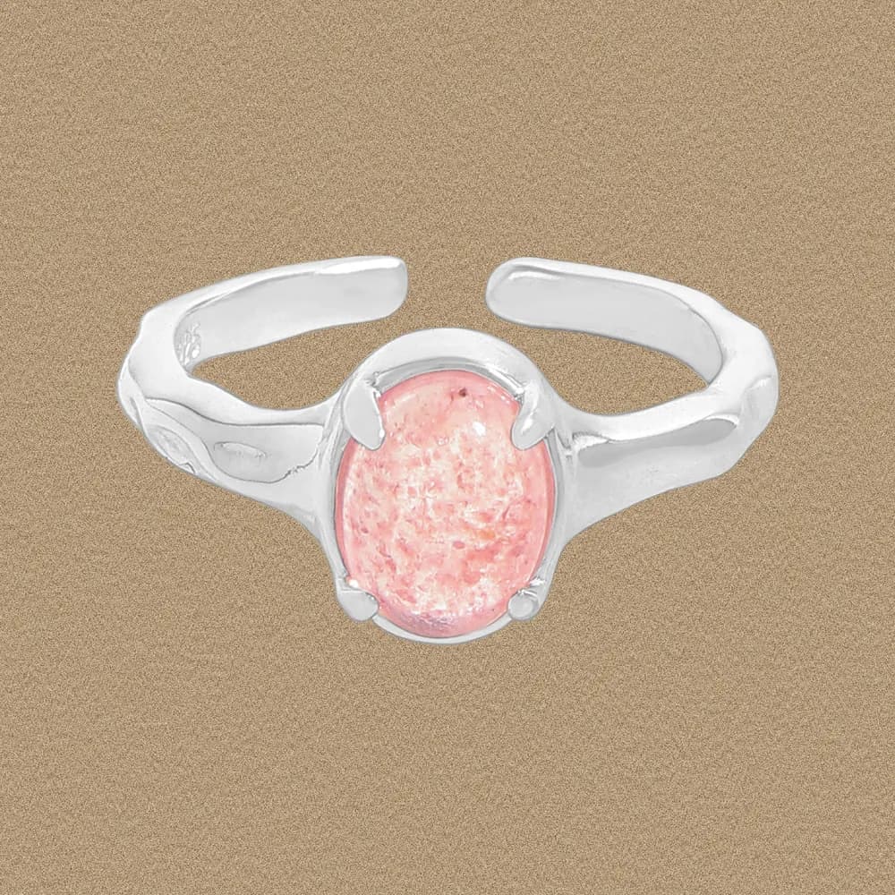 Sterling silver ring with an oval pink stone held in a bezel setting