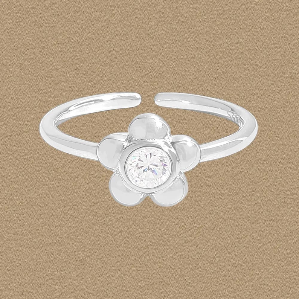 A polished sterling silver flower ring with a central clear crystal and five rounded petals.