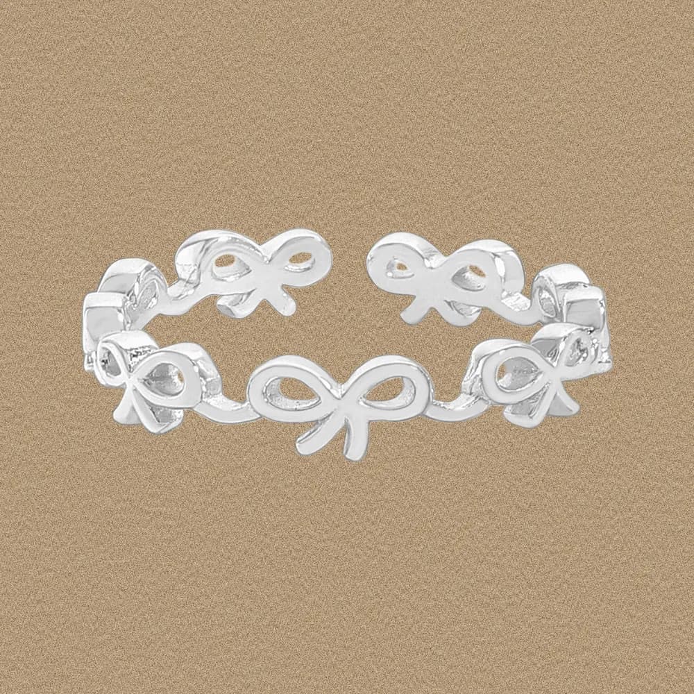 Polished sterling silver Bow Link Ring with interconnected bow motifs around the band.