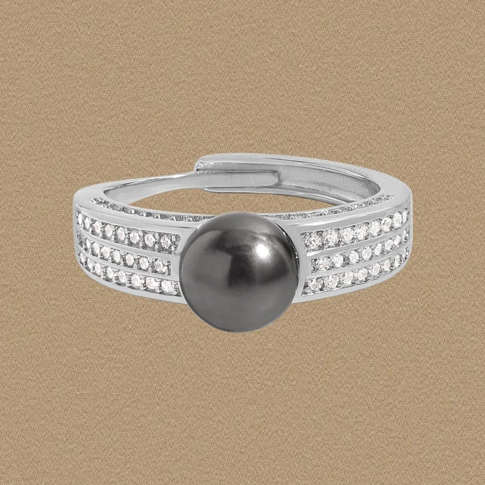 Silver polished ring with two pavé crystal bands and a large dark central bead