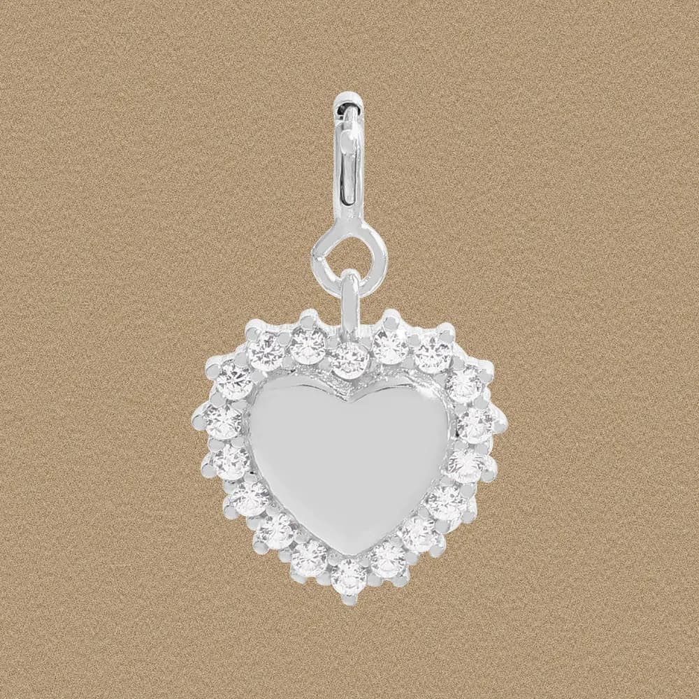 Polished sterling silver heart pendant with a crystal halo on a neutral background.
