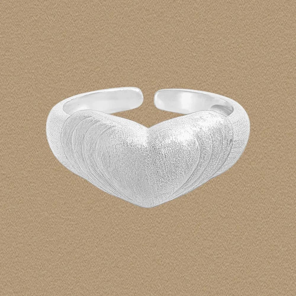 Open-cuff sterling silver ring with a brushed textured heart motif