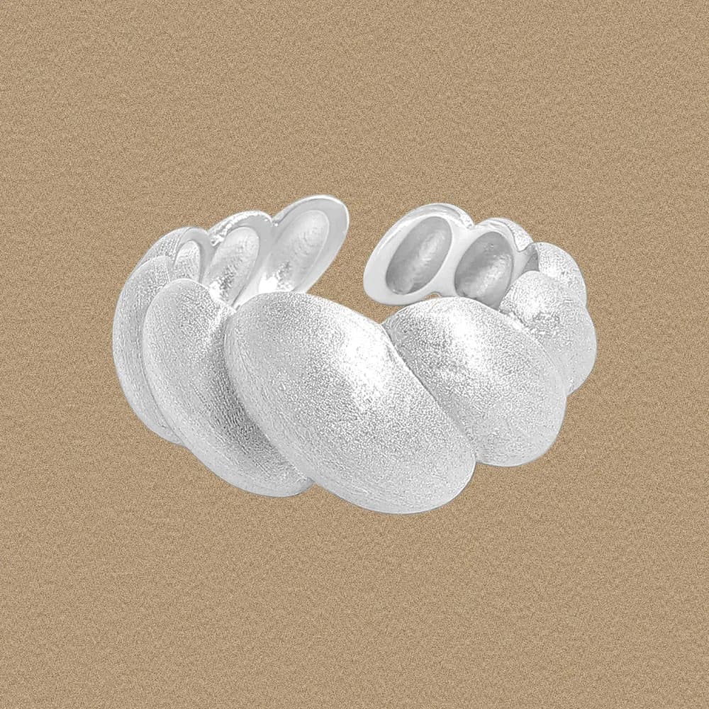 Sterling silver bubble cluster ring with overlapping ovals shown against a beige backdrop.