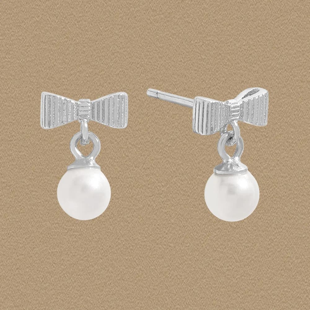 Silver bow stud earrings with a hanging white pearl drop