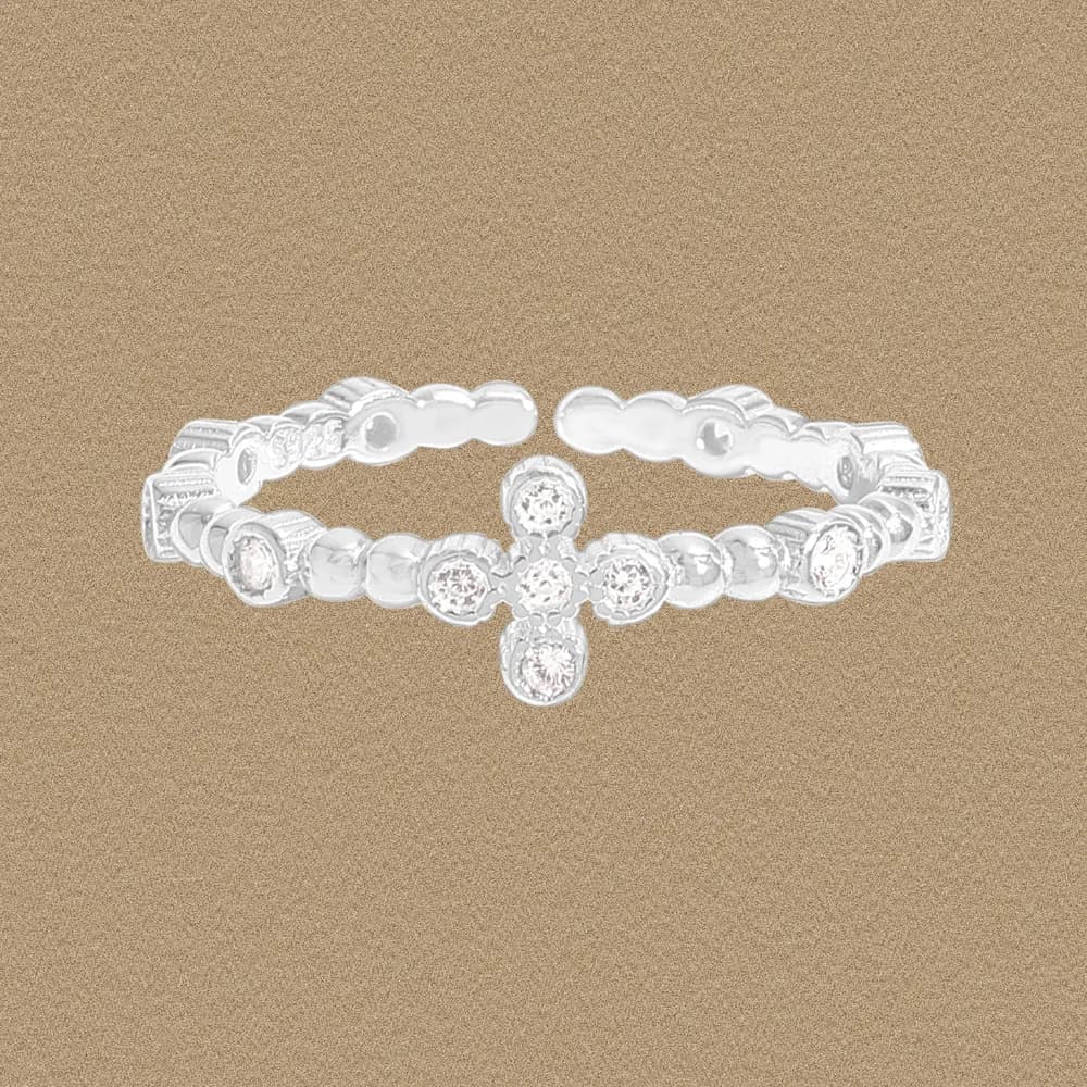 Polished sterling silver cross-pavé ring with two linked bands and a central gemstone-cross motif on a neutral background.