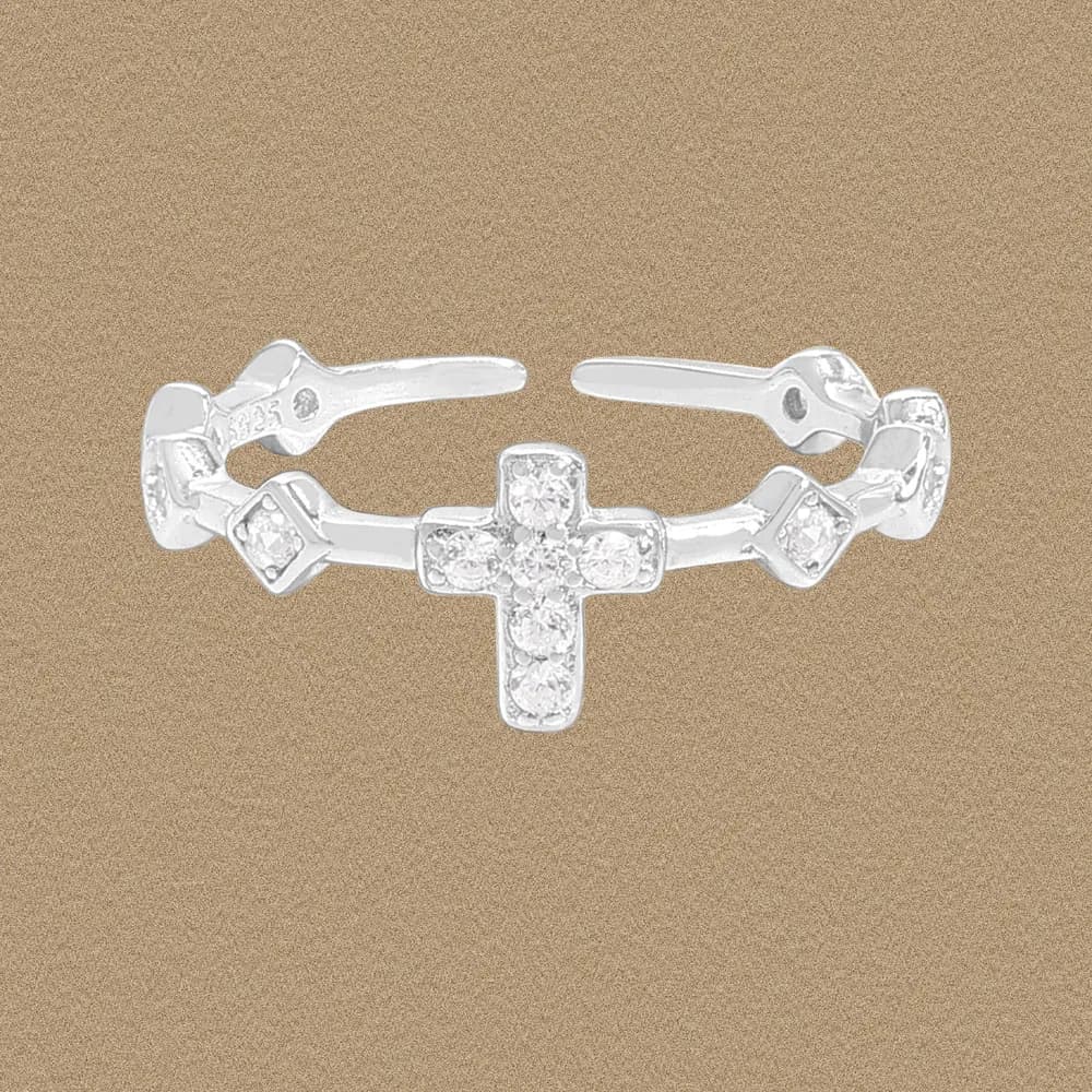 Polished sterling silver ring with a diamond-encrusted cross centerpiece and geometric side accents.