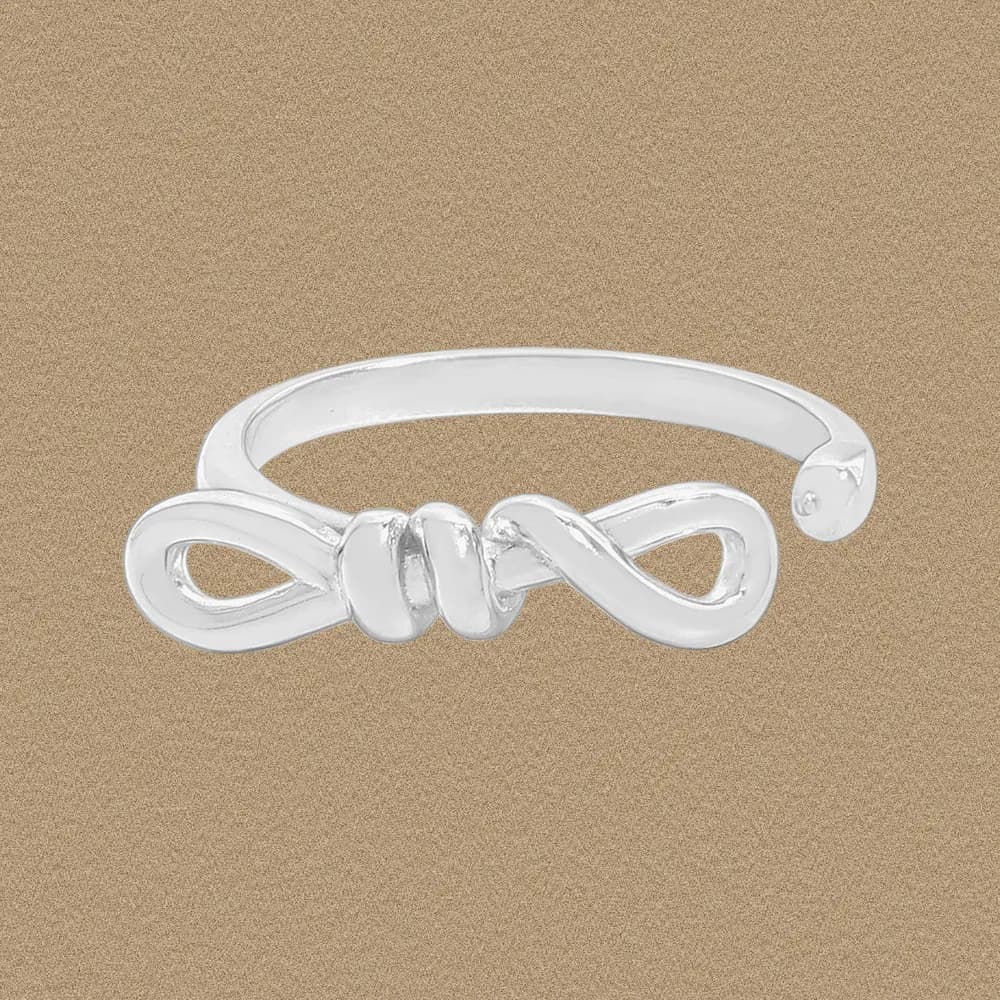 Polished sterling silver Infinity Knot Ring featuring an open band and twisted knot design.