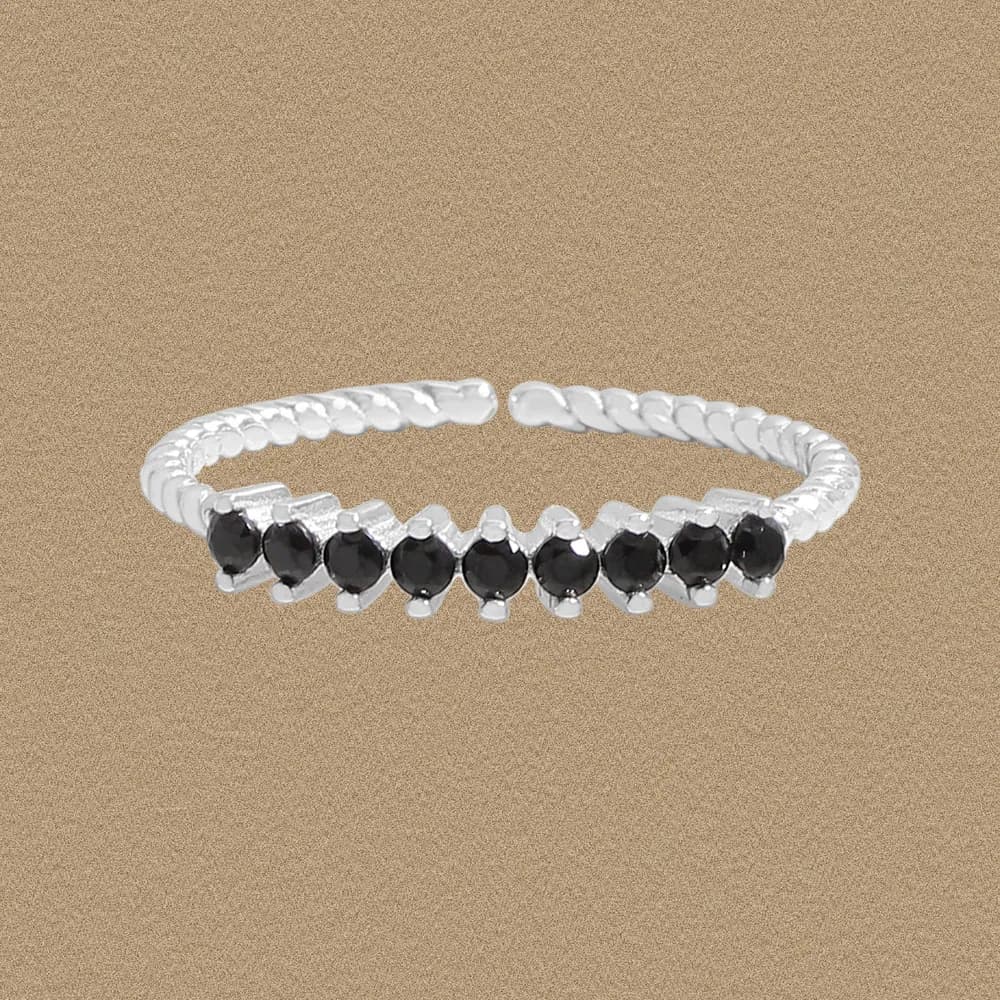 Polished sterling silver ring with a twisted band and a row of black stones across the top.