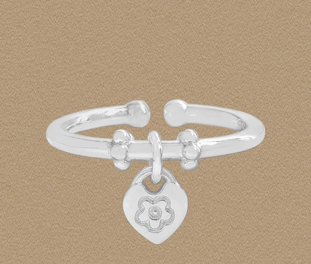 Polished sterling silver open-band ring with a hanging heart charm featuring a floral engraving.