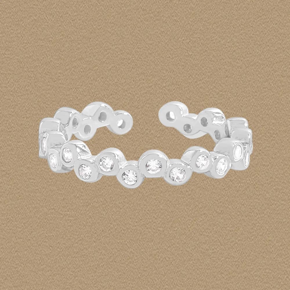 Polished sterling silver ring with circular bezel-set stones arranged along a linked band.