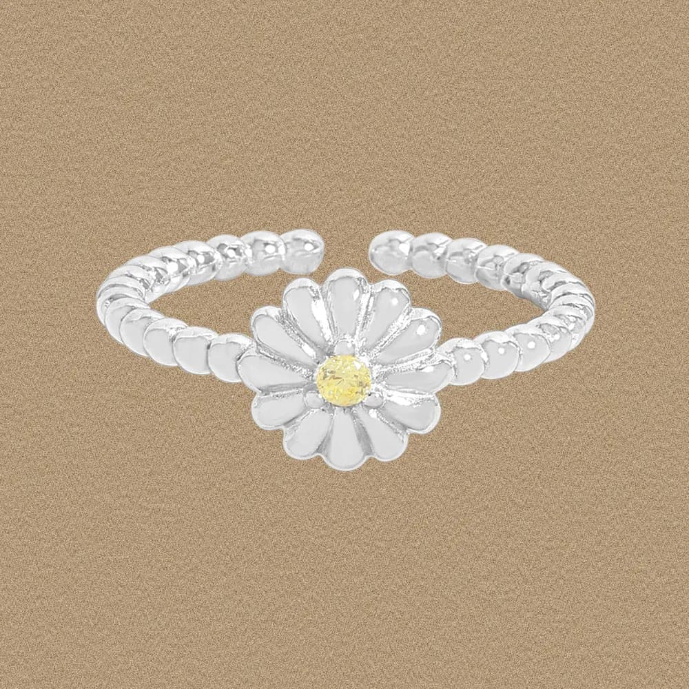Polished sterling silver daisy ring with a beaded band and a yellow center stone