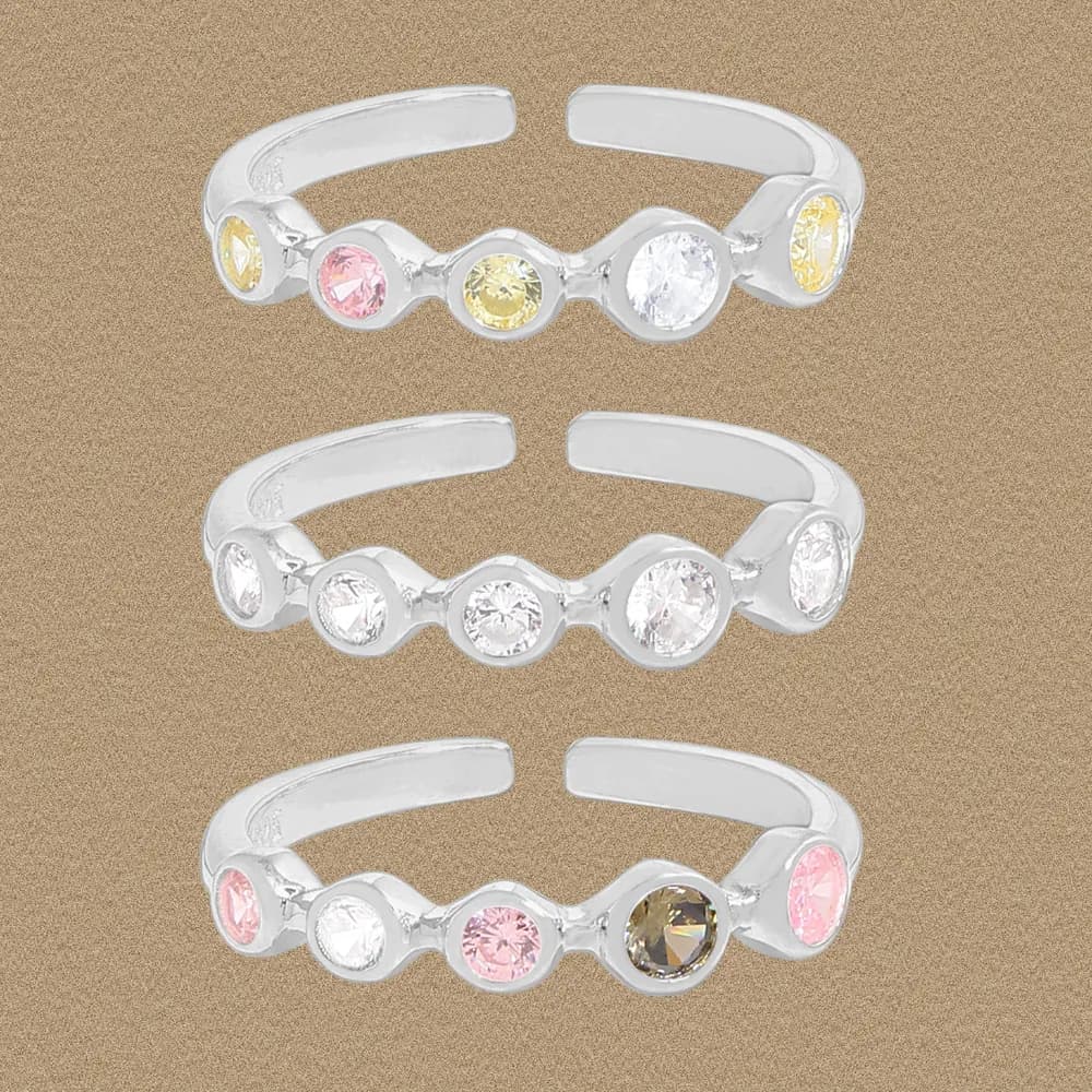 Open, adjustable sterling silver ring featuring five evenly spaced bezel-set stones along a curved band.