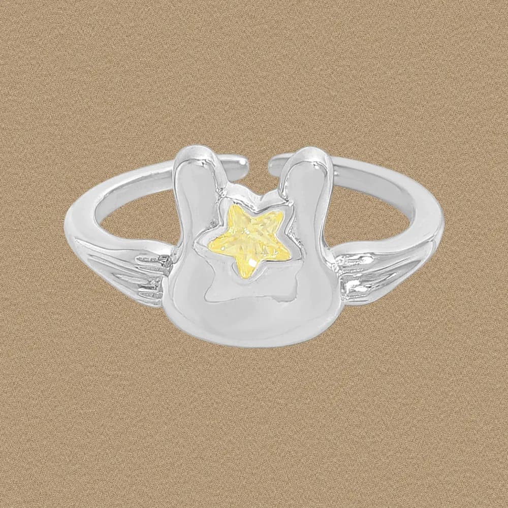 Polished sterling silver ring with a cloud-like centerpiece and a yellow star in the middle.