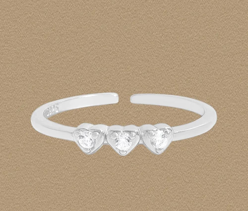 Open sterling silver ring with three heart-shaped stone settings across the front.
