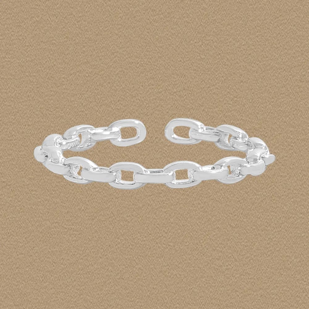 Polished sterling silver chain-link ring shown on a sandy-brown background.