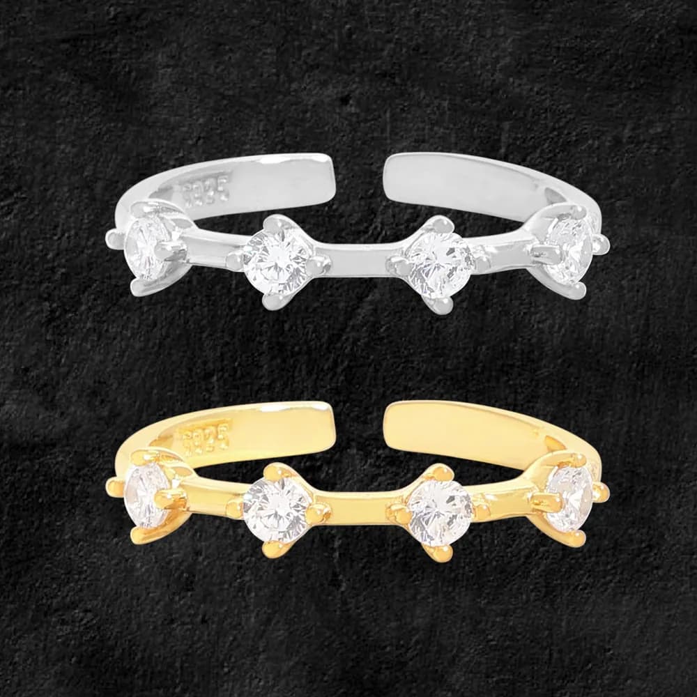 Polished ring in silver and gold-tone finishes featuring three round stones set along a curved band.