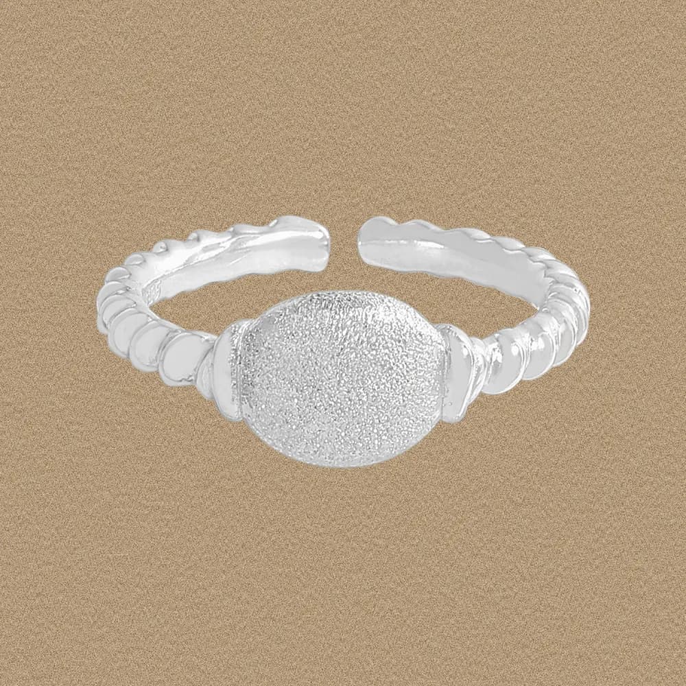 Open-ended sterling silver ring with a textured central disc and beaded band