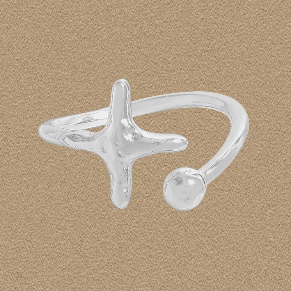 Polished sterling silver Star Cross Ring with a four-armed star motif and a small ball accent on an open band.