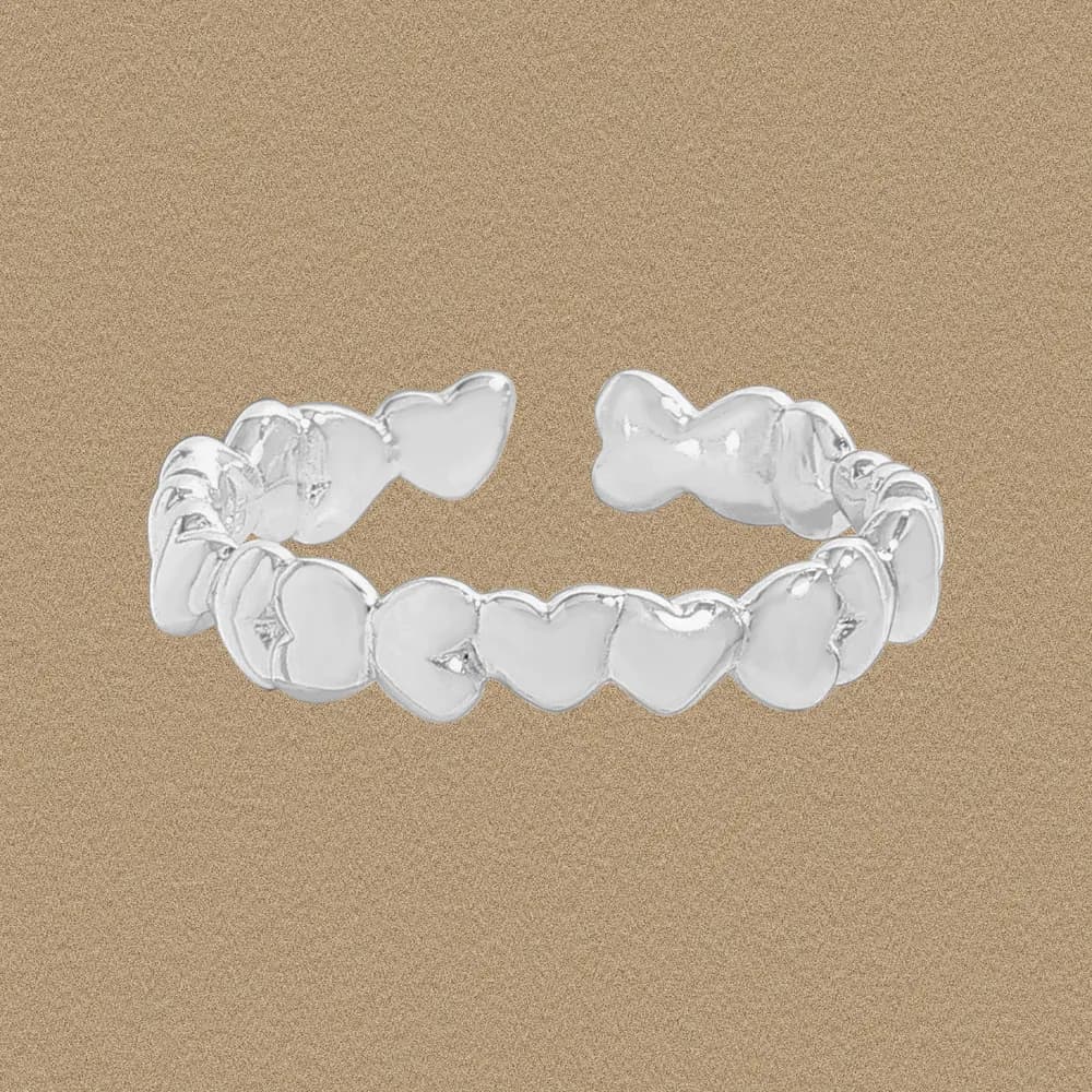 Polished sterling silver ring with a row of heart-shaped domes on an open adjustable band.