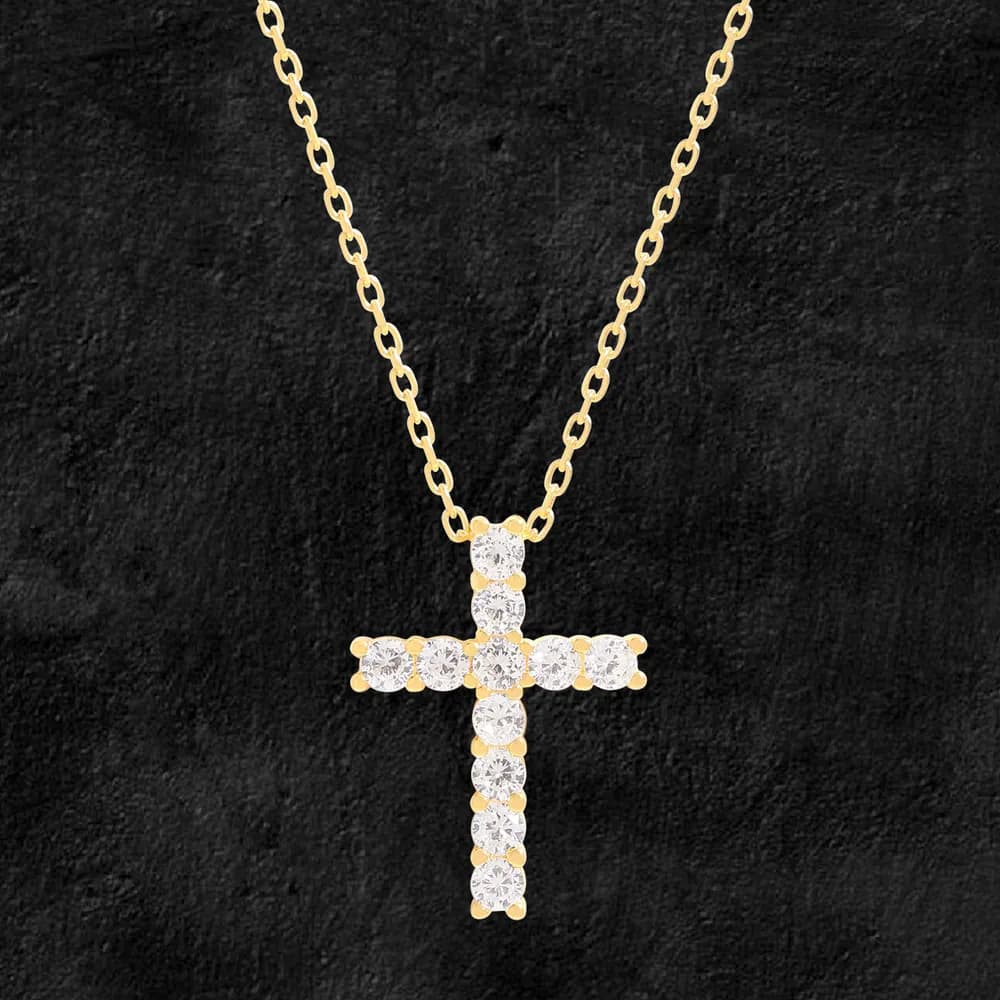 Polished gold-tone chain necklace with a crystal-studded cross pendant.
