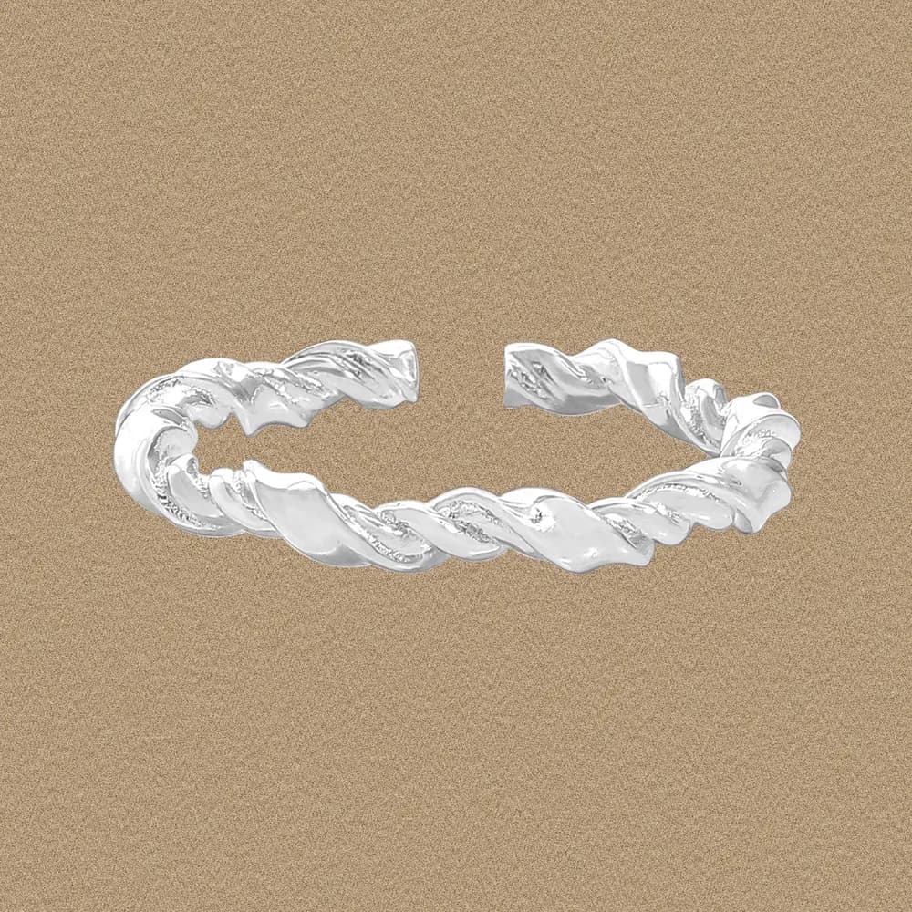 Polished sterling silver twisted rope ring with an open gap on a warm beige background.
