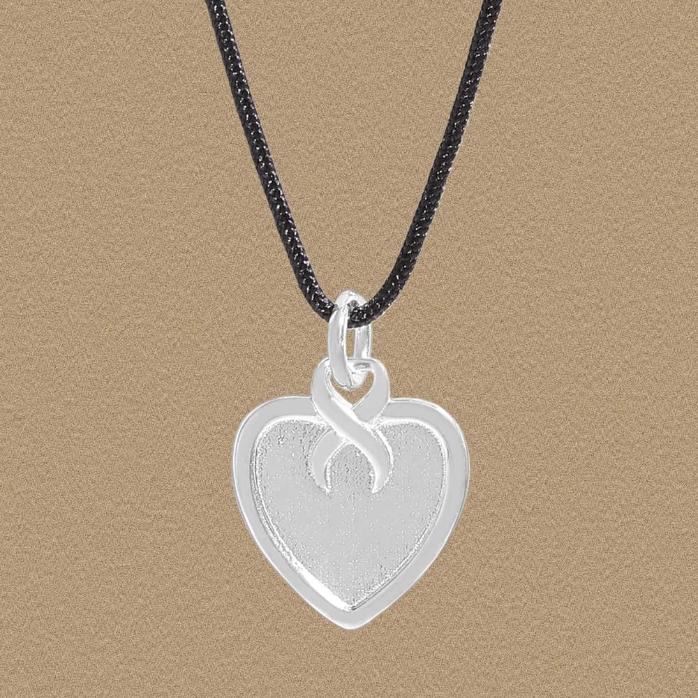 Sterling silver heart pendant with infinity loop on a black cord necklace.