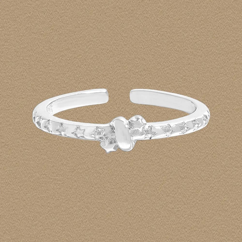 Polished sterling silver open cuff ring with star cutouts along the band and a central oval accent.