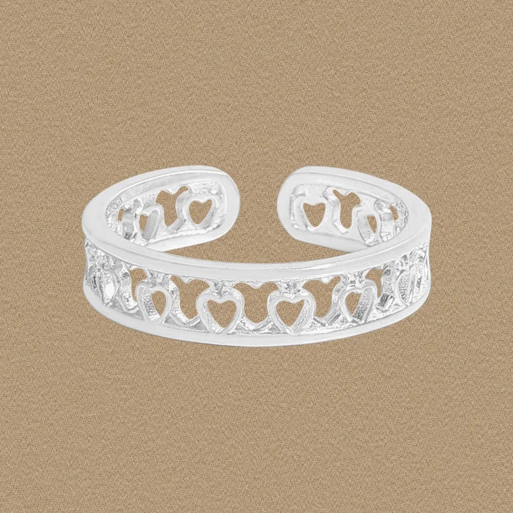 Polished sterling silver ring with repeating heart cutouts forming an open cuff.