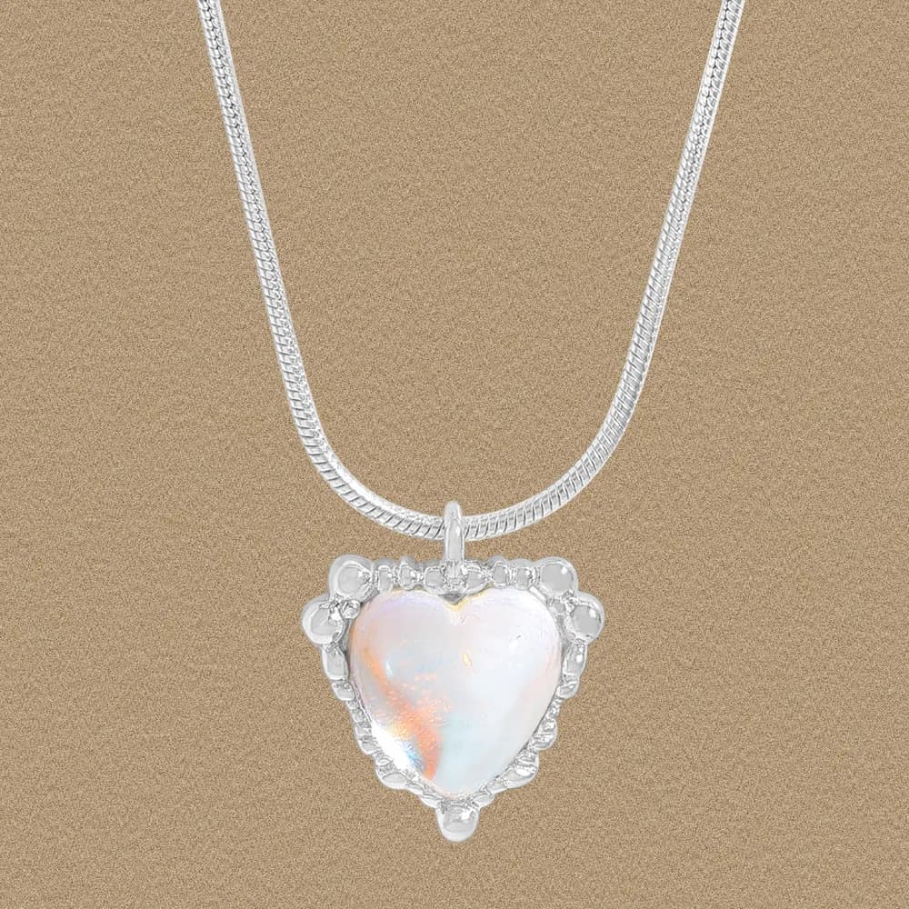 Polished silver heart-shaped opal pendant on a matching chain