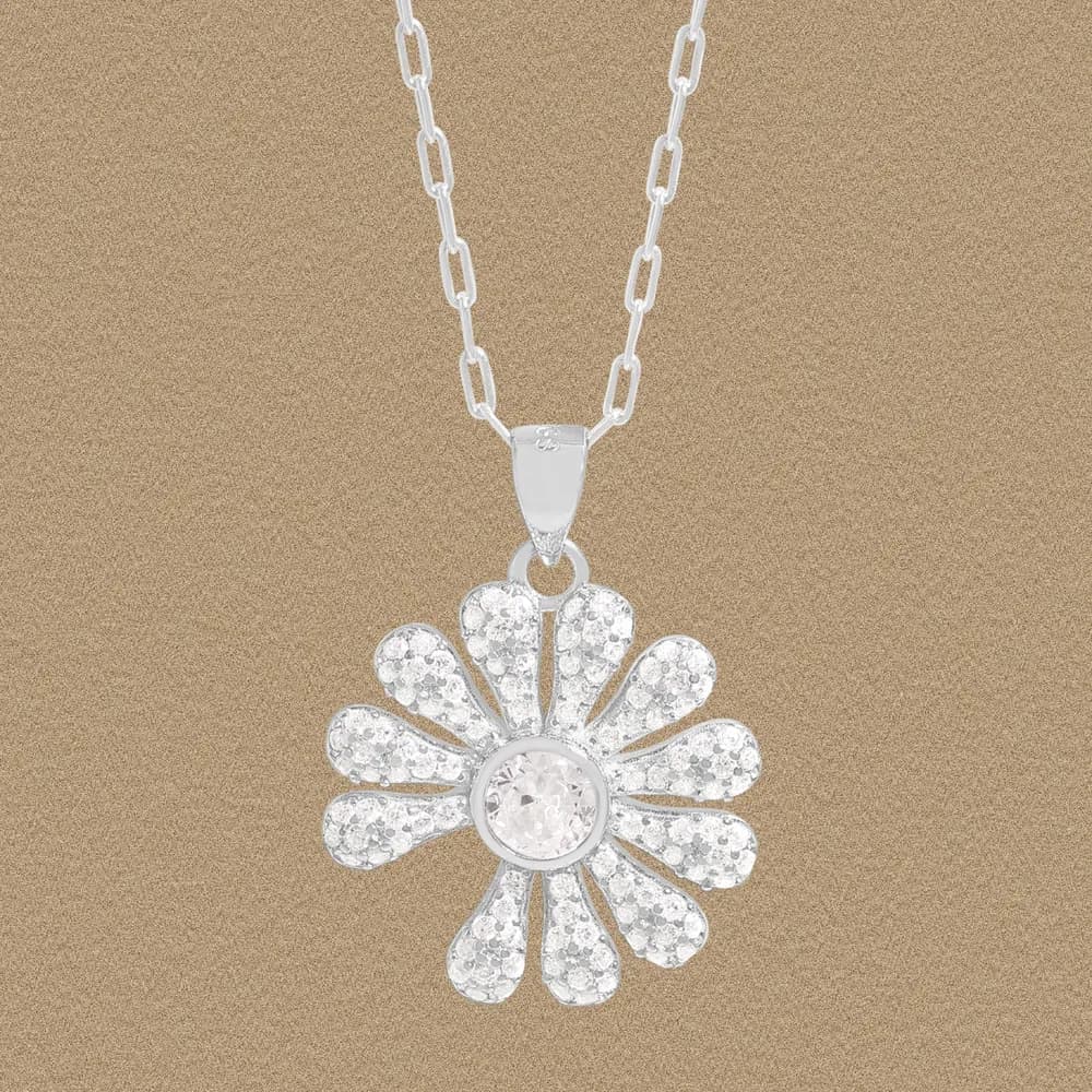 Polished sterling silver daisy pendant necklace with pavé petals on a simple chain.
