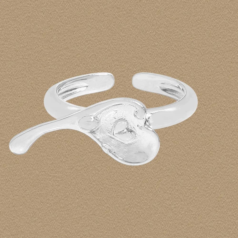 Polished sterling silver ring with a heart cutout on an open, adjustable band.