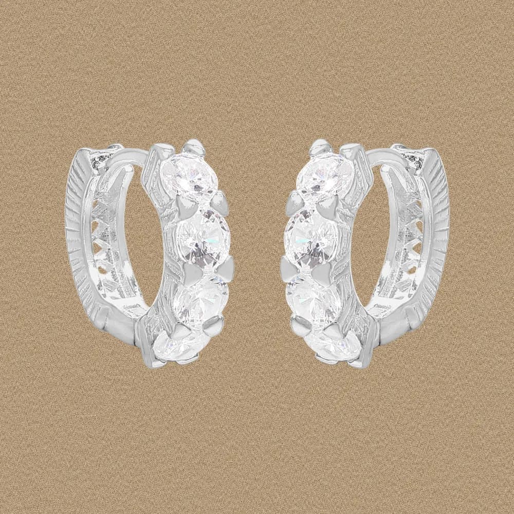 Polished sterling silver hoop earrings with a crystal-studded outer edge and hinged closure.